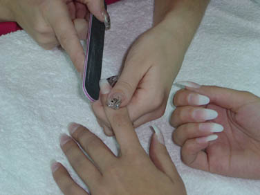 Shape the free edge and blend the tip into natural nail.